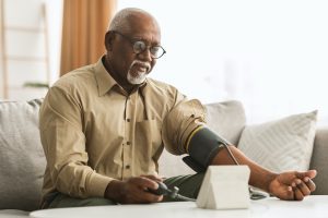 Senior Black Man Measuring Arterial Blood Pressure At Home